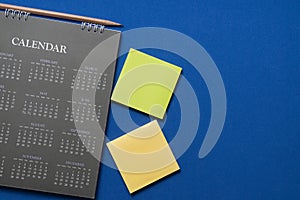 Calendar on the blue table background, planning for business meeting or travel planning concept