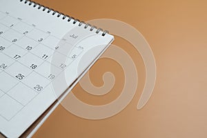 calendar on the brown table background, planning for business meeting or travel planning concept