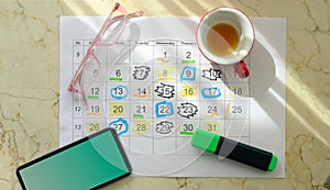 Calendar with business appointments,pens,coffee cup and spectacles, monthly schedule. Business concept,beat the clock