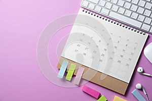 Calendar and computer keyboard on the pink table background, planning for business meeting or travel planning concept