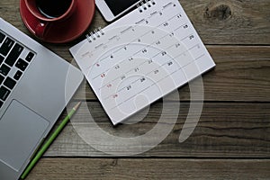 Calendar and computer on the table, planning for business meeting or travel planning concept