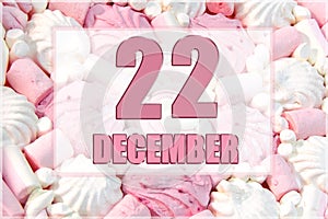 calendar date on the background of white and pink marshmallows. December 22 is the twenty-second day of the month