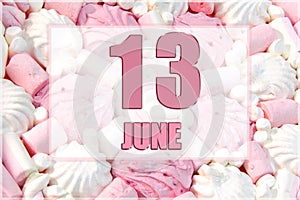 calendar date on the background of white and pink marshmallows. June 13 is the thirteenth day of the month