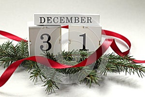 Calendar for December 31 : cubes with the numbers 3 and 1 on spruce branches, the name of the month