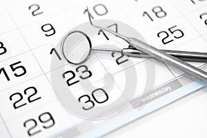 Calendar and dental instruments close-up. Dental health and teeth care concept