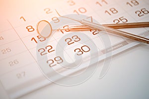 Calendar and dental instruments close-up. Dental health and teeth care concept