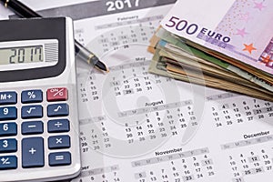 calendar with euro bills with calculator pen