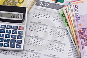 calendar with euro bills with calculator pen