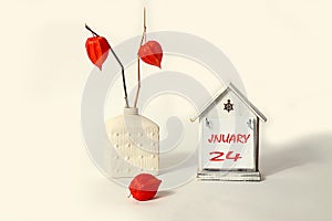 Calendar for January 24: a decorative house with the name of the month of January in English, the numbers 24 are written on it, a