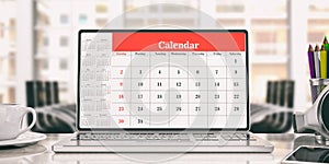 Calendar on a laptop screen, office background