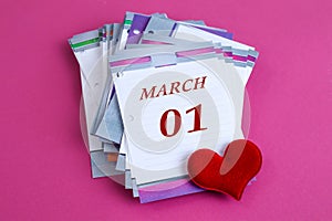 Calendar for March 1: desk calendar with the name of the month of March in English, numbers 01, red heart on a pastel background,