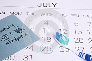 Calendar with a marked date and toothbrush.