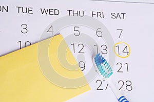 Calendar with a marked date and toothbrush.