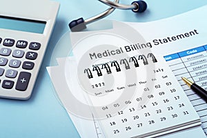 Calendar on medical bills with calculator, healthcare payment