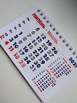 The calendar. The month is June. Calendar on a white background. July 2021. Photo of the calendar on the phone. Vertical photo.