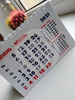 The calendar. The month is June. Calendar on a white background. July 2021. Photo of the calendar on the phone. Vertical photo.