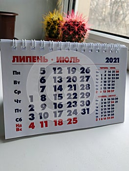 The calendar. The month is June. Calendar on a white background. July 2021. Photo of the calendar on the phone. Vertical photo.