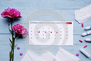 Calendar with pads, tampons, pills and roses