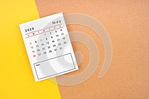 Calendar page for May 2024 on a yellow and brown