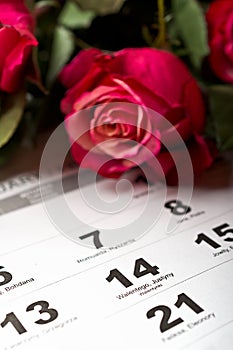 Calendar page with the red hearts and bouquet of red roses on Valentines day.