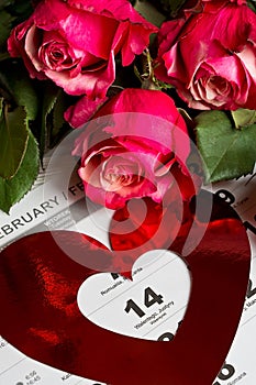 Calendar page with the red hearts and bouquet of red roses on Valentines day.