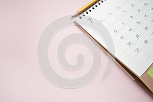 calendar on the pink table background, planning for business meeting or travel planning concept