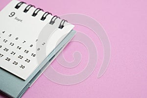 calendar on the pink table background, planning for business meeting or travel planning concept