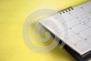 Calendar placed on a light yellow background photo