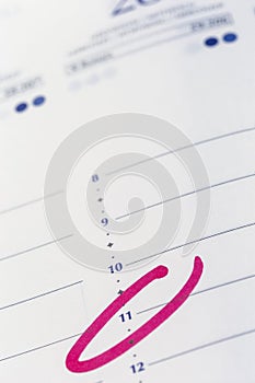 Calendar. planning an hour circled in pink marker to remind meetings