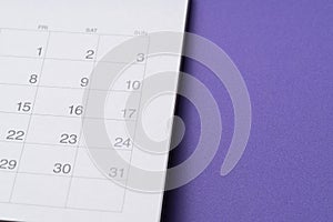 Calendar on the purple table background, planning for business meeting or travel planning concept