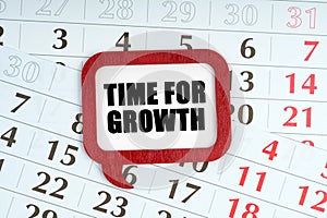 On the calendar, a red plaque with the words inside - TIME FOR GROWTH