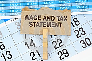 On the calendar and reporting documents is a cardboard plate with the inscription - Wage and Tax Statement