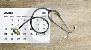 Calendar, stethoscope, on a blue background, health care concept