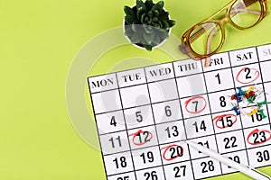 Calendar on the table with green background, planning a business meeting or travel planning concept