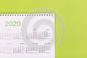 Calendar on the table with green background, planning a business meeting or travel planning concept