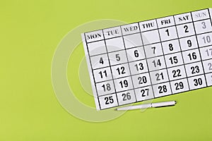 Calendar on the table with green background, planning a business meeting or travel planning concept