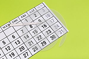 Calendar on the table with green background, planning a business meeting or travel planning concept