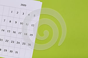 Calendar on the table with green background, planning a business meeting or travel planning concept