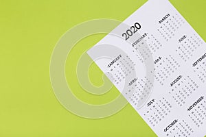 Calendar on the table with green background, planning a business meeting or travel planning concept