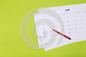 Calendar on the table with green background, planning a business meeting or travel planning concept