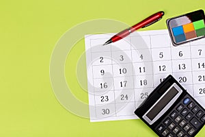 Calendar on the table with green background, planning a business meeting or travel planning concept