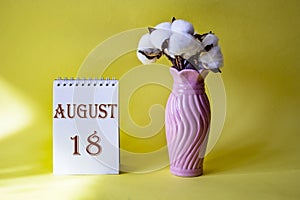 Calendar with text 18 august and with a vase of flowers