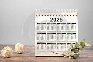 Calendar Year 2025 schedule. 2025 desk calendar notepad on wooden table and gray background. New Year. plans for 2025. gray