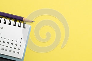 calendar on the yellow table background, planning for business meeting or travel planning concept