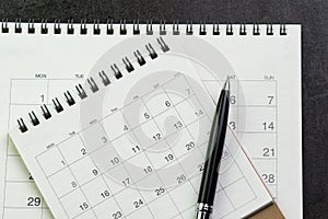 Calendars with pen on black background using as date orgainizer