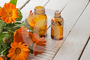 Calendula and bottles with medicines. Concept homeopathy.