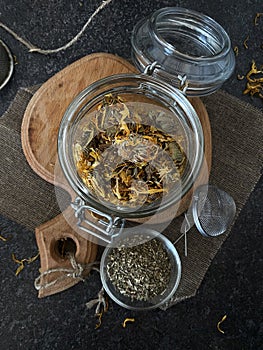 Calendula flowers in a glass jar. Useful herbal tea to boost immunity