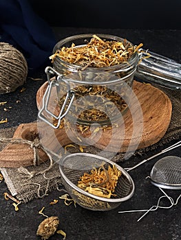 Calendula flowers in a glass jar. Useful herbal tea to boost immunity