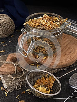 Calendula flowers in a glass jar. Useful herbal tea to boost immunity