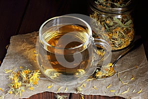 Calendula herbal dried tea in a glass cup
